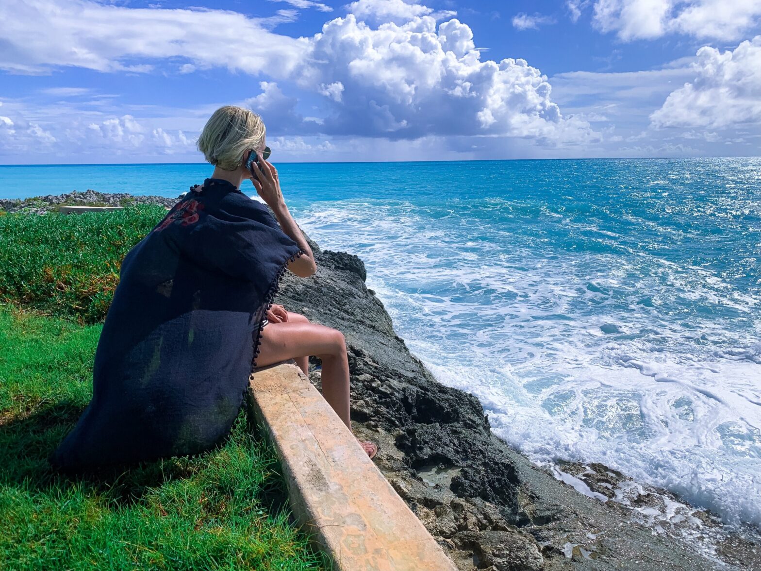 Woman on cliff top over looking sea. people-centric learning