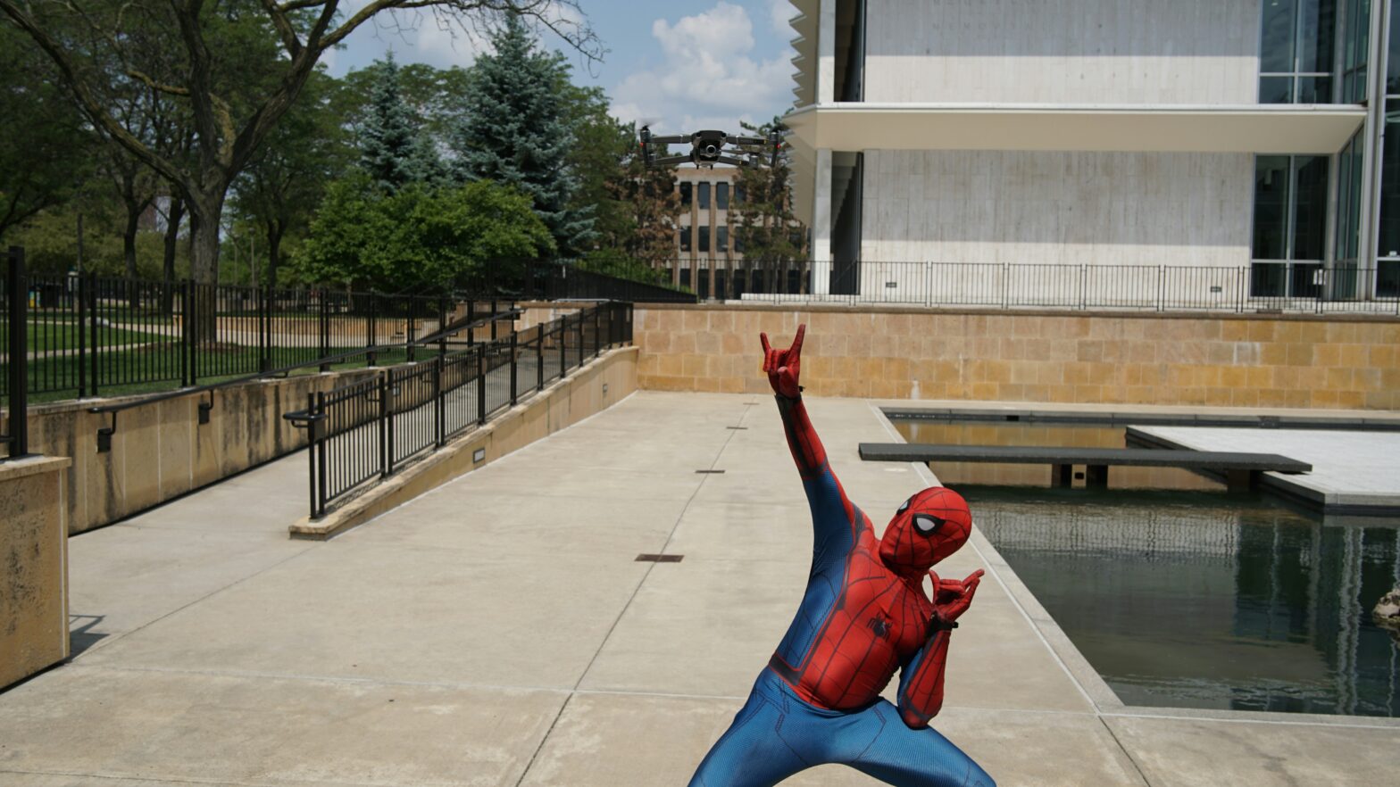 Spiderman outside an office, a Superhero Manager development programme graduate. Photo by Stem List on Unsplash