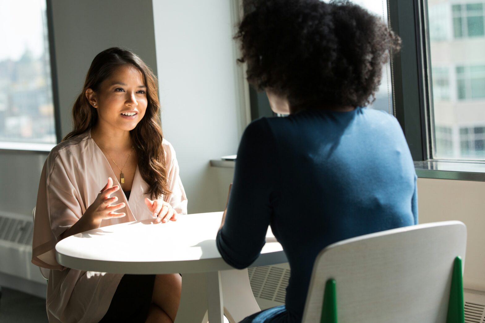 two women discussing a returner to the workforce. Photo by Christina @ wocintechchat.com on Unsplash